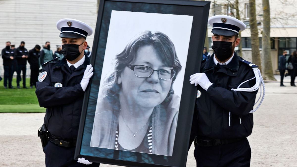 French police officers carry the portrait of Stephanie Monferme during the remembrance gathering in Rambouillet.