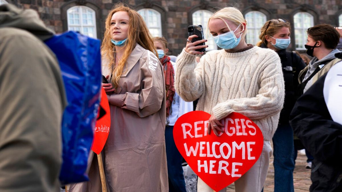 People attend a demonstration against the tightening of Denmark's migration policy and the deportation orders in Copenhagen, Denmark, Wednesday, April 21, 2021. 