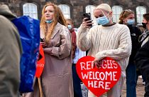 People attend a demonstration against the tightening of Denmark's migration policy and the deportation orders in Copenhagen, Denmark, Wednesday, April 21, 2021.