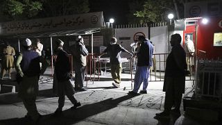 Afghans wait outside the hospital to see their relatives in Kabul, Afghanistan, Friday, April 30, 2021.