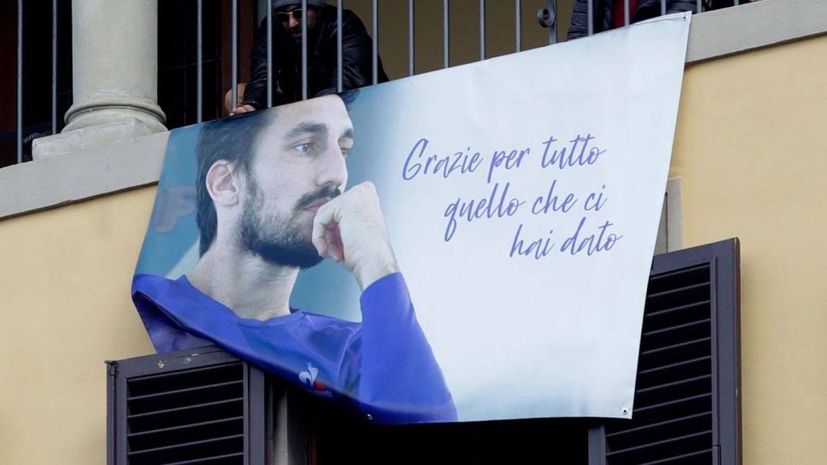 Supporters display a poster during the funeral ceremony of Davide Astori in Florence in March 2018.