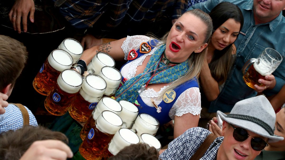 In this Saturday, Sept. 21, 2019 file photo, a waitress holds twelve glasses of beer during the opening of the 186th 'Oktoberfest' beer festival in Munich, Germany