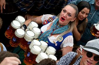 In this Saturday, Sept. 21, 2019 file photo, a waitress holds twelve glasses of beer during the opening of the 186th 'Oktoberfest' beer festival in Munich, Germany