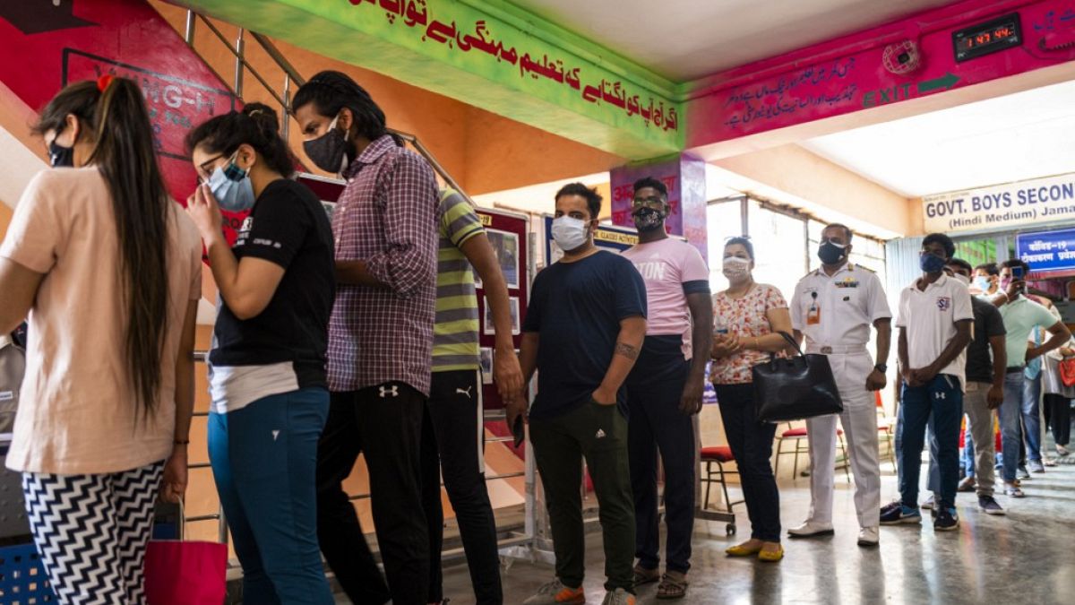 People line up to get the Covid-19 coronavirus vaccine in a school-turned-vaccination centre in New Delhi on May 3, 2021.