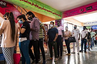 People line up to get the Covid-19 coronavirus vaccine in a school-turned-vaccination centre in New Delhi on May 3, 2021.