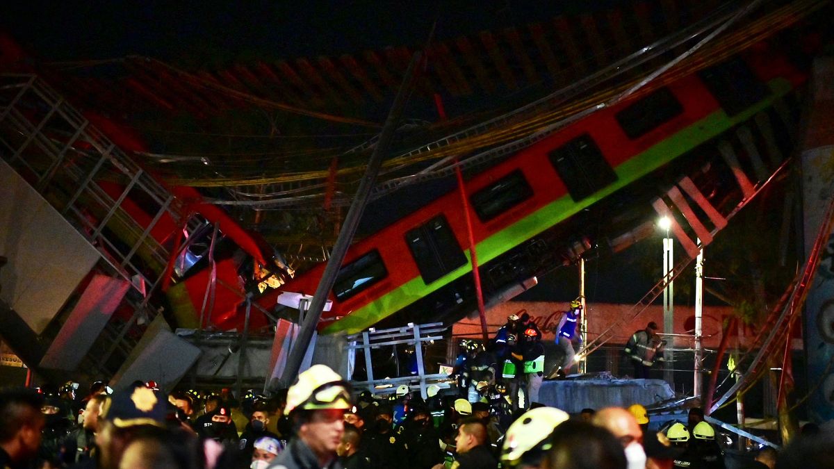 Rescue workers gather at the site of a metro train accident after an overpass for a metro partially collapsed in Mexico City on May 3, 2021. 