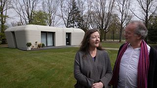 Tenants Elize Lutz and Harrie Dekkers in front of their new home.