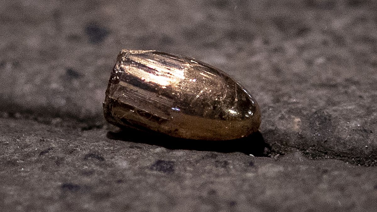 FILE - In this Feb. 19, 2020 file photo, a projectile lies on the sidewalk near a restaurant at the scene of a shooting in central Hanau, Germany. 