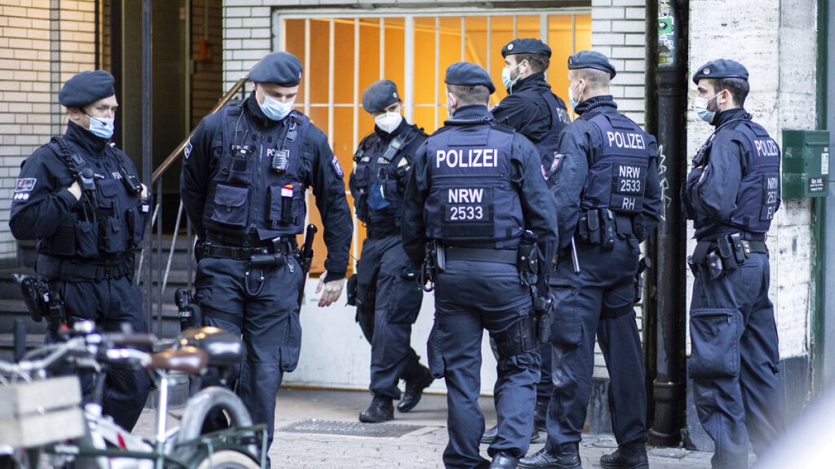 Police officers in front of an Ansaar International building in Duesseldorf, Germany on Wednesday