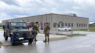 Financial police stand guart outside a modified courthouse in Calabria, Italy at the opening of a 'maxi-trial' of more than 350 alleged 'ndrangheta members in January