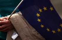 A pro-EU demonstrator holds an EU flag prior to the arrival of Jean-Claude Juncker and Boris Johnson in Luxembourg on Monday, 16 September, 2019.