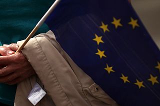 A pro-EU demonstrator holds an EU flag prior to the arrival of Jean-Claude Juncker and Boris Johnson in Luxembourg on Monday, 16 September, 2019.