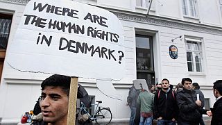 Syrian refugees hold banners outside the Swedish Embassy in Copenhagen, Denmark on Wednesday, 26 September, 2012. 