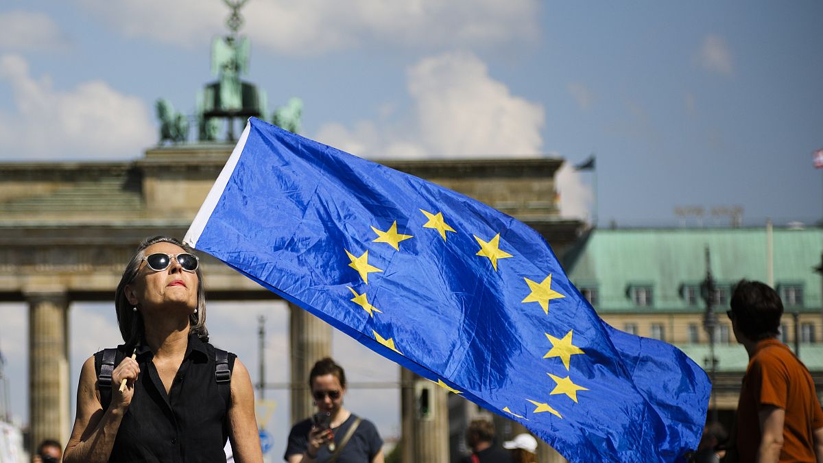 FILE: A woman holds a European flag as she attends a demonstration in Berlin, Germany, Sunday, May 19, 2019.