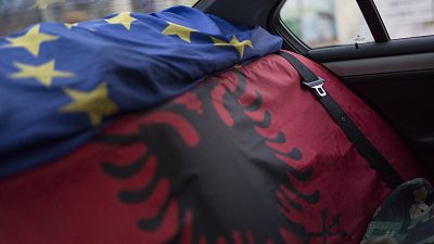 An EU flag and an Albanian flag cover the back seats of a car in the town of Ballsh, Albania on Thursday July 9, 2020. 