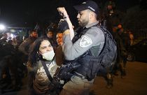 A Palestinian woman scuffles with Israeli border police officer during a protest against the planned evictions of Palestinian families in the Sheikh Jarrah