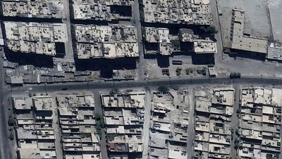 This satellite image shows road damage and craters, in the Sha'ar district of Aleppo, Syria, Sept. 18, 2016. 