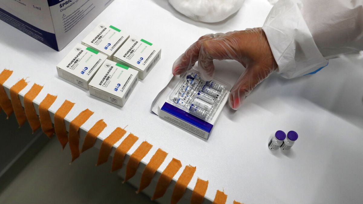 A medical worker prepares vials of the COVID-19 vaccines, Chinese Sinopharm, left, Sputnik V, center, and Pfizer at a vaccine centre, in the Usce shopping mall in Belgrade.