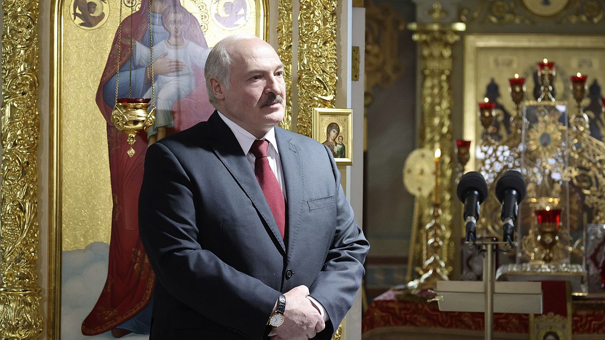 Belarusian President Alexander Lukashenko, left, attends the Orthodox Easter service in the town of Turov, some 270 km (167 miles) south of Minsk, Belarus, Sunday, May 2, 2021