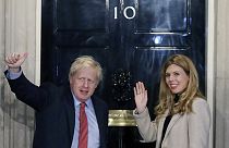 Boris Johnson and his partner Carrie Symonds wave from the steps of number 10 Downing Street (Dec 2019)