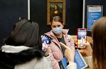 Students stood by Da Vinci's great masterpiece, the Mona Lisa