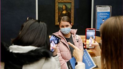 Students stood by Da Vinci's great masterpiece, the Mona Lisa Students stood by Da Vinci's great masterpiece, the Mona Lisa