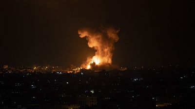 An explosion caused by Israeli airstrikes on the Gaza Strip is seen early Tuesday, May 11, 2021. 