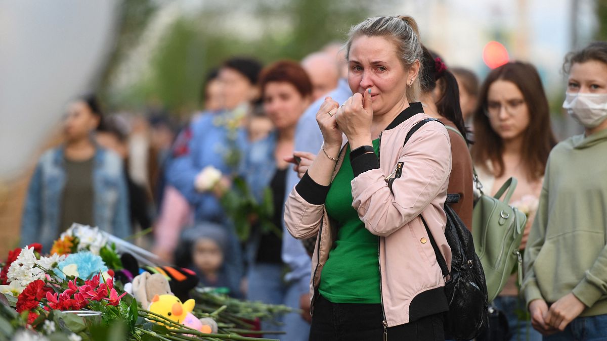 A woman reacts at a makeshift memorial for victims of the shooting at School No. 175 in Kazan.