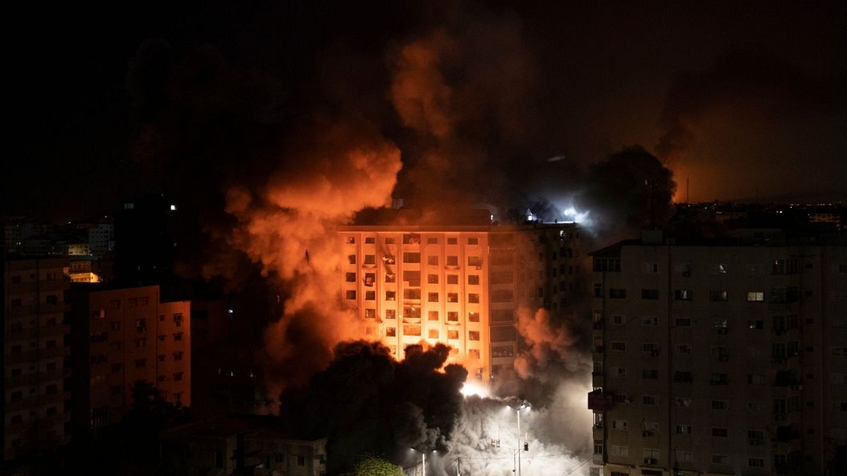 Smoke caused by Israeli airstrikes are seen at a residential building in Gaza City