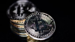 A physical imitation of the Bitcoin cryptocurrency is seen as Hungary moves to halve tax on crypto earnings.