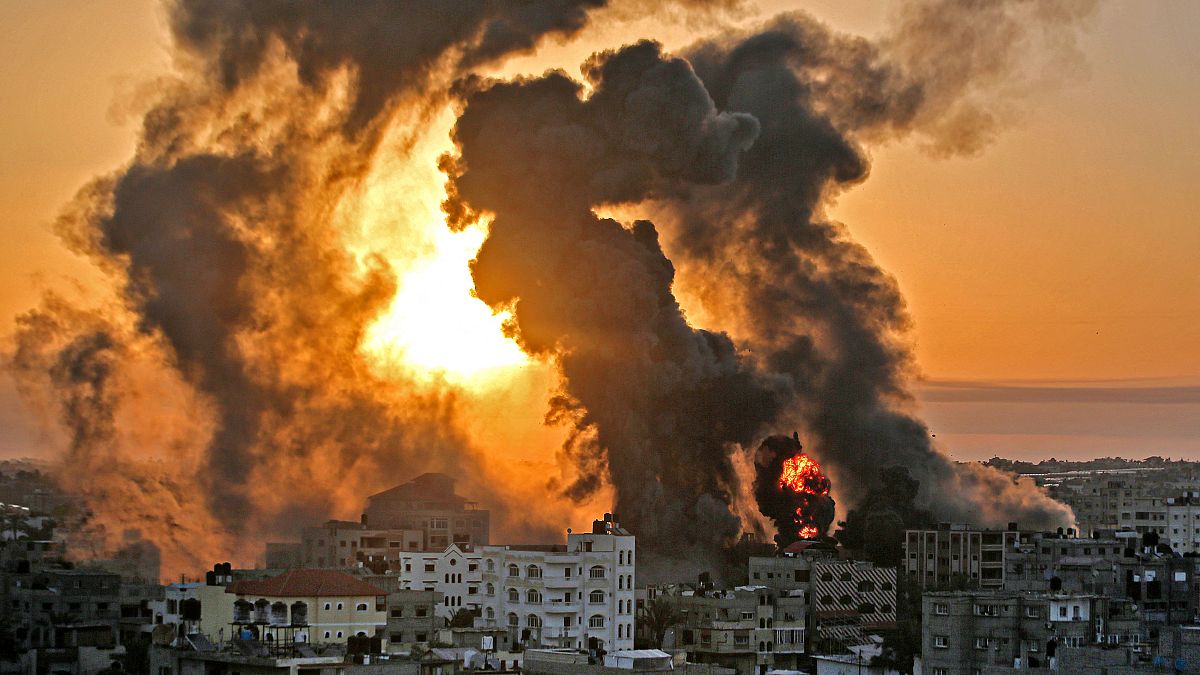 A fire rages at sunrise in Khan Yunish following an Israeli airstrike.