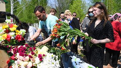 Mourners lay flowers at the grave of English teacher Elvira Ignatyeva.