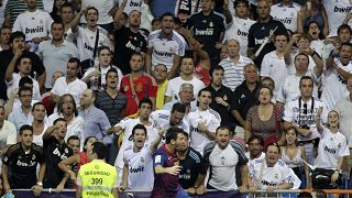 FILE:  Real Madrid fans follow the first leg of the Spanish Supercup soccer match at the Santiago Bernabeu stadium in Madrid Sunday Aug. 14, 2011. 