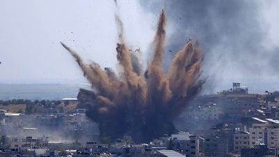 Smoke rises following Israeli airstrikes on a building in Gaza City, Thursday, May 13, 2021. 