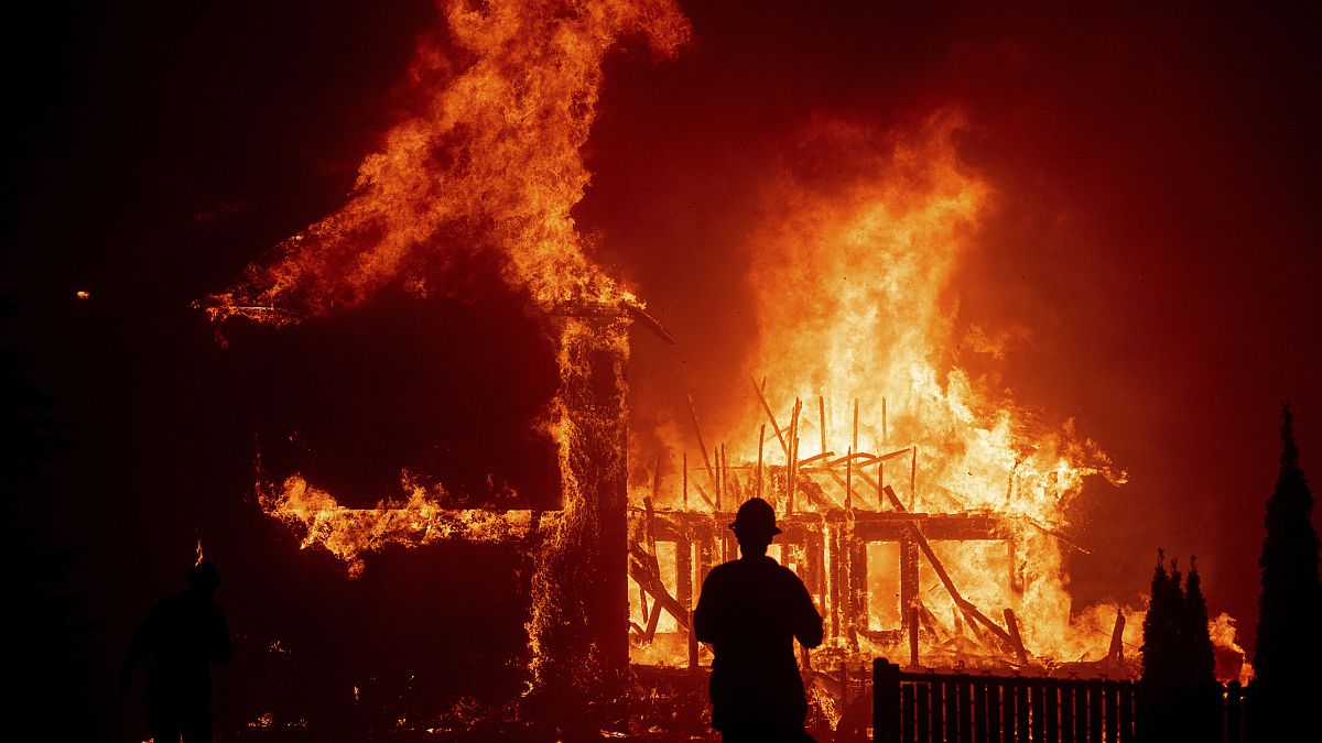 A home burns as a wildfire called the Camp Fire rages through Paradise, Calif.