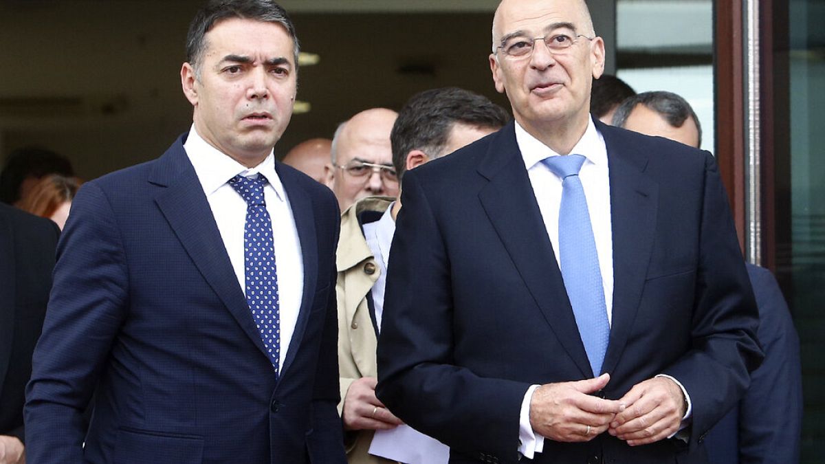 Greek Foreign Minister Nikos Dendias, right and his North Macedonia's counterpart Nikola Dimitrov
