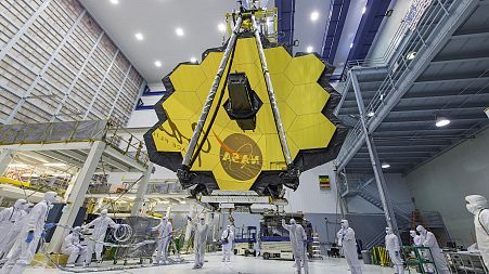  NASA technicians lift the mirror of the James Webb Space Telescope using a crane at the Goddard Space Flight Center .
