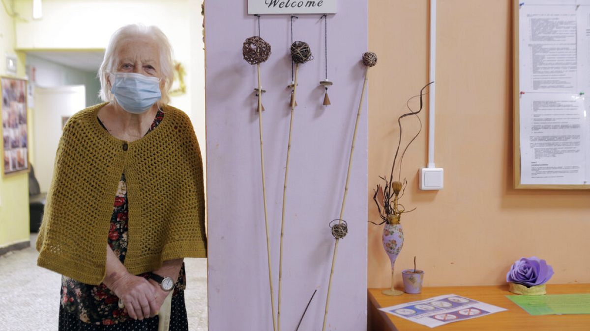 An elderly woman waits to receive a dose of the COVID-19 vaccine, at Nadezhda nursing home, in Sofia, Wednesday, Jan. 27, 2021
