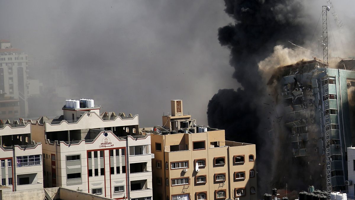 A view of a 11-story building housing AP office and other media in Gaza City is seen moments after Israeli warplanes demolished it, Saturday, May 15, 2021. 
