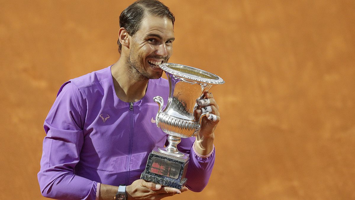 Spain's Rafael Nadal celebrates with the trophy after winning the Italian Open tennis tournament, in Rome