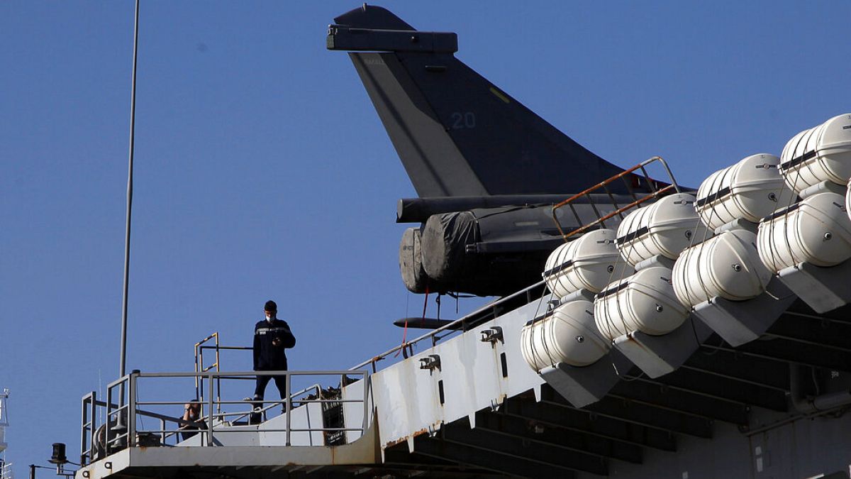 A French crew member walks on France's nuclear-powered aircraft carrier Charles de Gaulle at Limassol port, Cyprus,