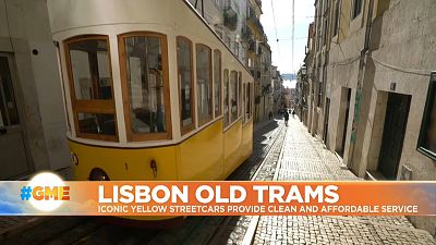 Iconic yellow streetcar up a hill in Lisbon, Portugal