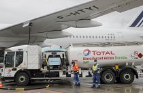Workers refuel an Airbus A350 with sustainable aviation fuel at Roissy airport, north of Paris, Tuesday, May 18, 2021.