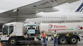 Workers refuel an Airbus A350 with sustainable aviation fuel at Roissy airport, north of Paris, Tuesday, May 18, 2021. 