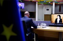 European Council President Charles Michel, left, speaks with Georgian President Salome Zurabishvili, on screen, during a video conference at the European Council on April 19