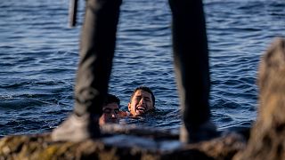 A Spanish civil guard awaits the arrival of migrants to the Spanish enclave of Ceuta, near the Moroccan-Spanish border, on Wednesday, May 19, 2021.