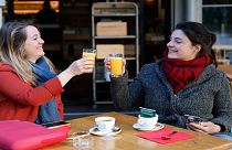 Women enjoy a cafe and an orange juice at a café terrace Wednesday, May, 19, 2021 in Strasbourg, eastern France.