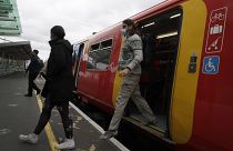 Passengers step off a train in London, Thursday, May 20, 2021.