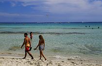 A couple walk on the beach in the southeast resort of Ayia Napa, Cyprus on May 16, 2021.