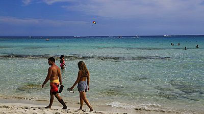 A couple walk on the beach in the southeast resort of Ayia Napa, Cyprus on May 16, 2021.